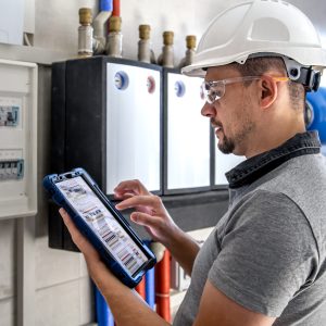 electrical-technician-looking-focused-while-working-switchboard-with-fuses-scaled.jpg